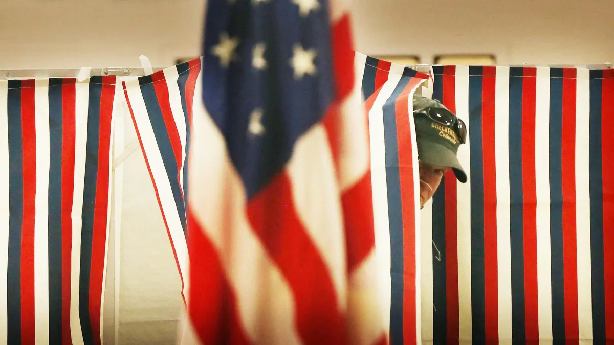A man exits a voting booth inside a middle school serving as a voting station on the day of the New Hampshire Primary in Bow, N.H., on Feb. 9, 2016. (Spencer Platt/Getty Images)
