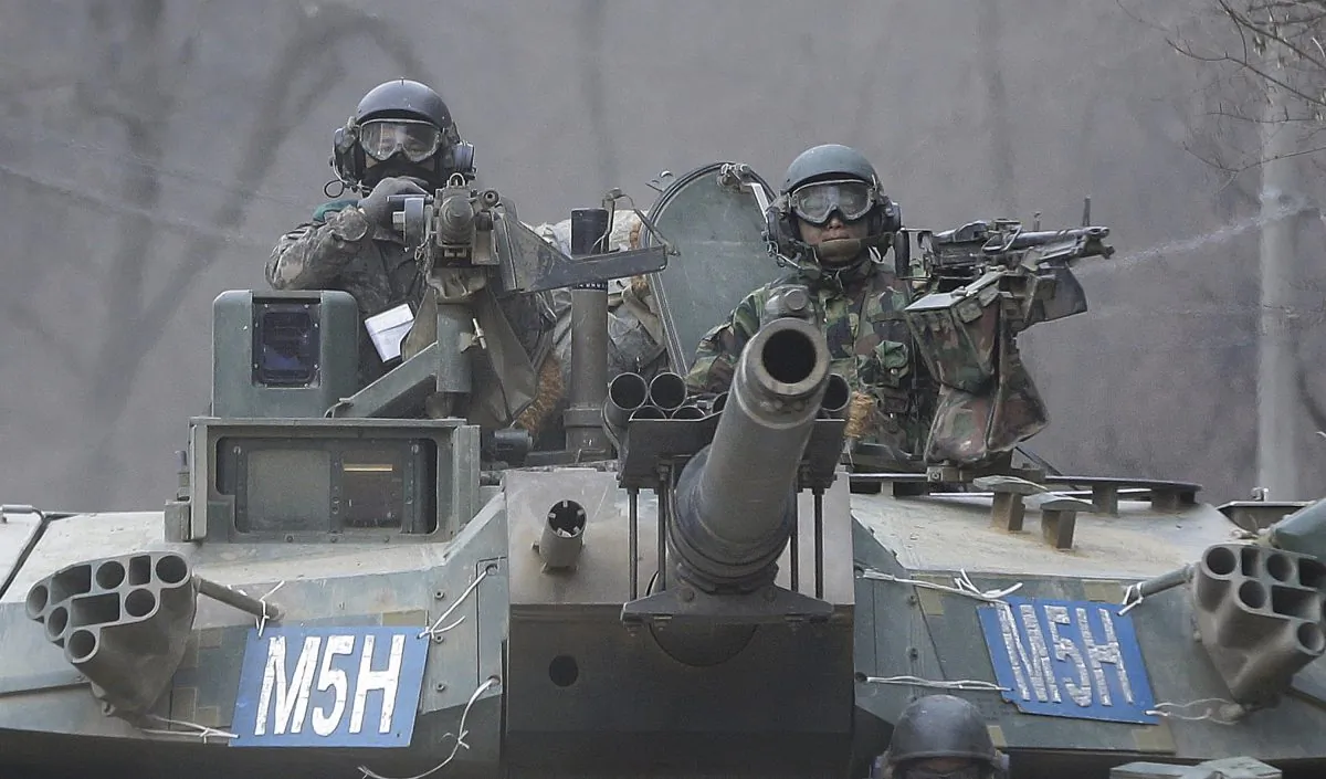 South Korean army soldiers ride a K-1 tank during the annual exercise in Paju, near the border with North Korea, on Feb. 19, 2016. (AP Photo/Ahn Young-joon)