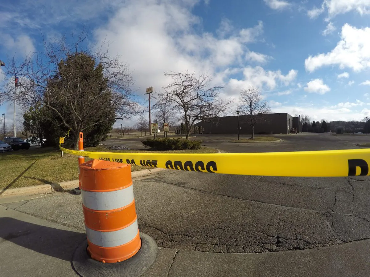 Police tape surrounds the area of a random shooting on Sunday, Feb. 21, 2016, in Kalamazoo, Mich.  Jason Dalton of Kalamazoo County was arrested early Sunday in downtown Kalamazoo following a massive manhunt after several victims were shot at random. (AP Photo/Mike Householder)
