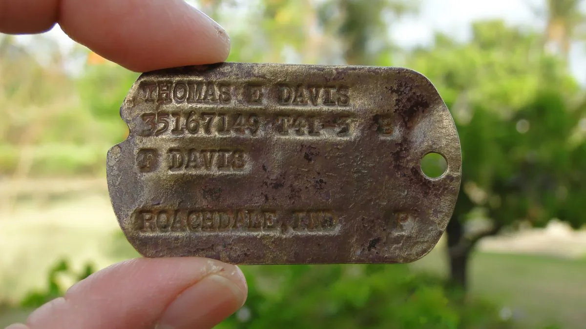 This Feb. 13, 2016 photo provided by Genevieve Cabrera shows World War II Pfc. Thomas E. Davis Army dog tag that was found in a farm field in Saipan in early 2014.  Davis earned one of the nation's highest military honors after surviving the bloody fighting on Saipan only to die during the even bloodier battle for Okinawa nearly a year later. (Genevieve Cabrera via AP)