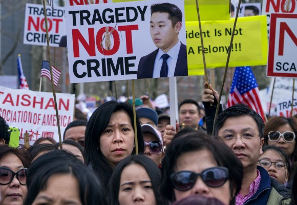 Protesters at a rally in the Brooklyn borough of New York Saturday in support of a former NYPD police officer Peter Liang, who was convicted of manslaughter for the 2014 shooting death of Akai Gurley, in a housing project stairwell, on Feb. 20, 2016. (AP Photo/Craig Ruttle)