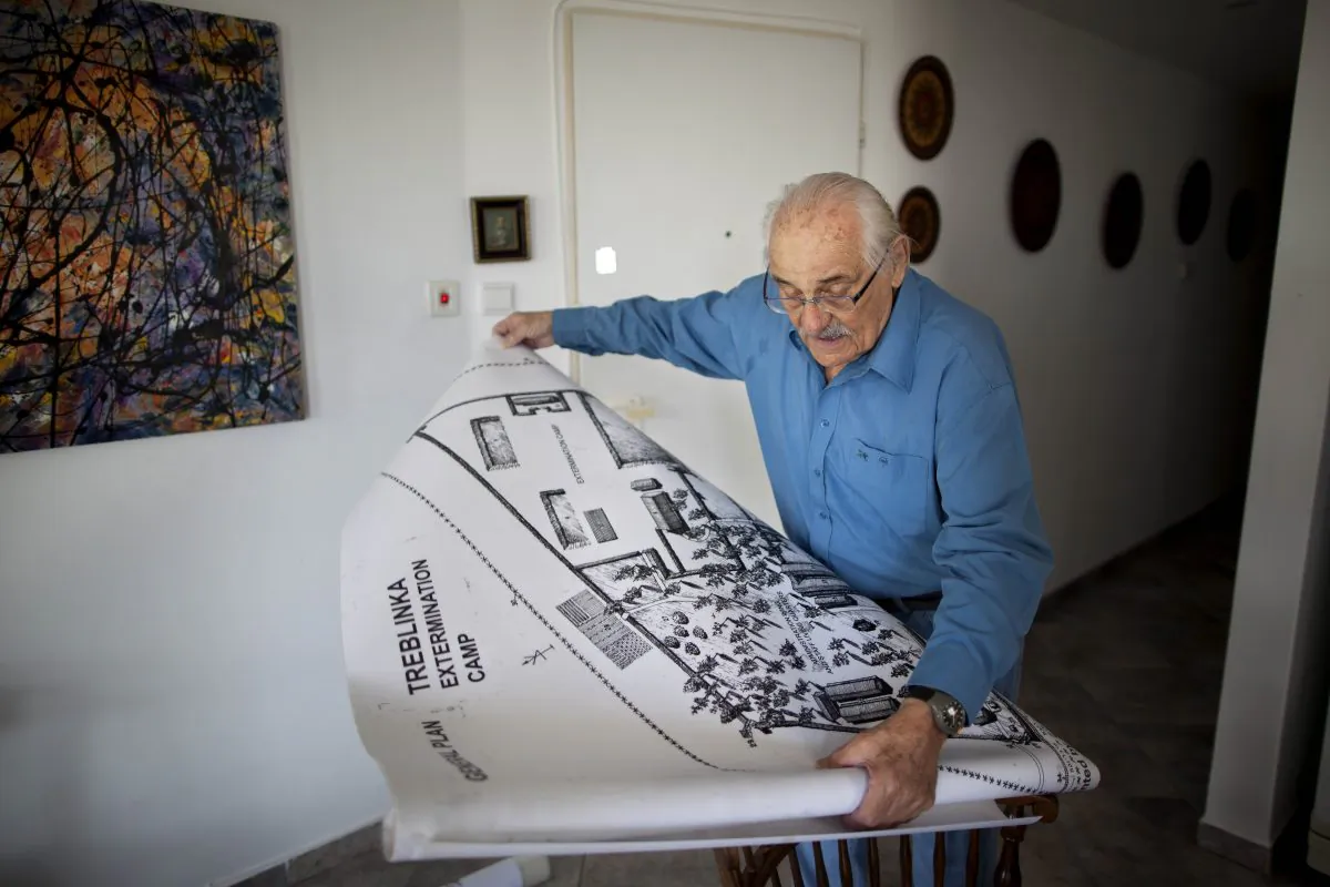 Holocaust survivor Samuel Willenberg displays a map of Treblinka extermination camp during an interview with the Associated Press in Tel Aviv, Israel, on Oct. 31, 2010. Willenberg, the last survivor of Treblinka, the Nazi death camp where 875,000 people were killed, has died at 93. Willenberg was among a group of Jews who in 1943 set fire to the camp and headed to the woods. Hundreds fled, but most were killed by Nazi troops in the surrounding mine fields or captured by Polish villagers. (AP Photo/Oded Balilty)