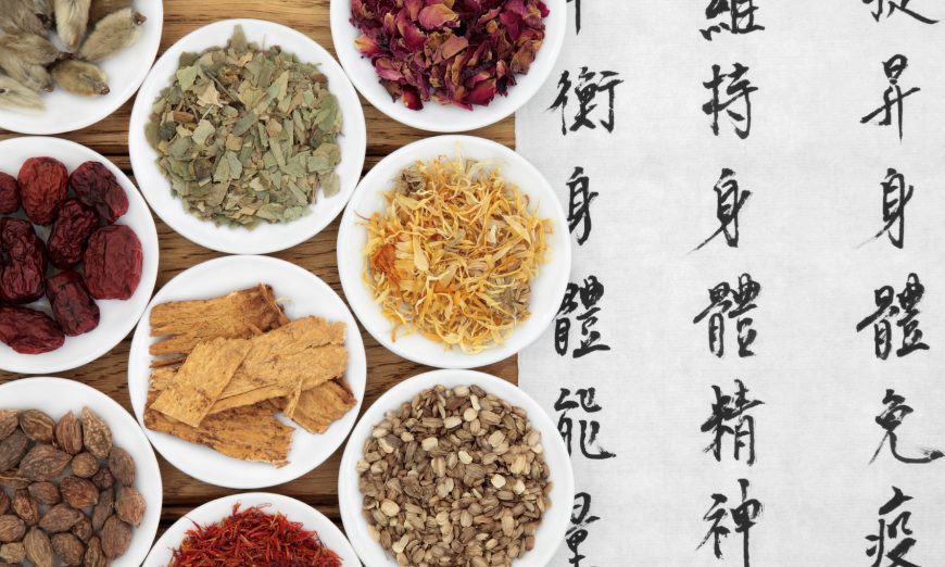 Chinese herbal medicine selection with mandarin calligraphy script. Translation describes the functions to increase the bodys ability to maintain body and spirit health and balance energy. (marilyna/iStock)