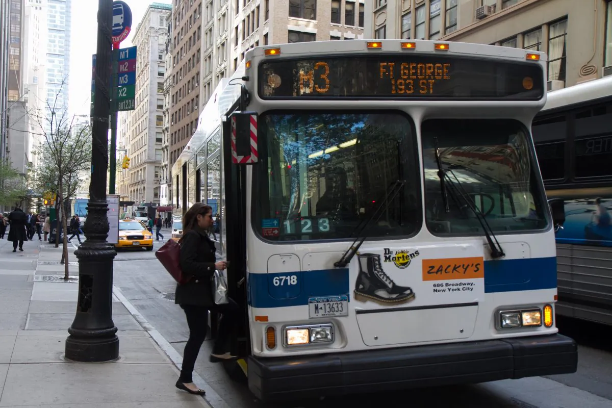 Commuters board a bus near