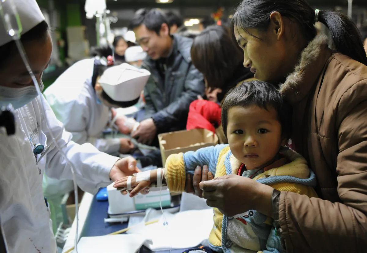 A group of Chinese children accompanied by their parents get treatment for flu at a hospital in Hefei, east China's Anhui Province, on Jan. 8, 2010.(STR/AFP/Getty Images)