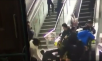 Crowded Escalator in China Suddenly Changes Direction Causing Pile-Up
