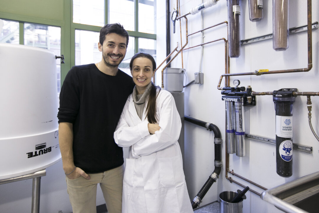 Organic Gemini founders Mariam Kinkladze and George Papanastasatos in front of the 4-step water purification system the company uses to make its TigerNut Horchata, in their new manufacturing facility in Brooklyn, New York, on Feb. 18, 2016. (Samira Bouaou/Epoch Times)