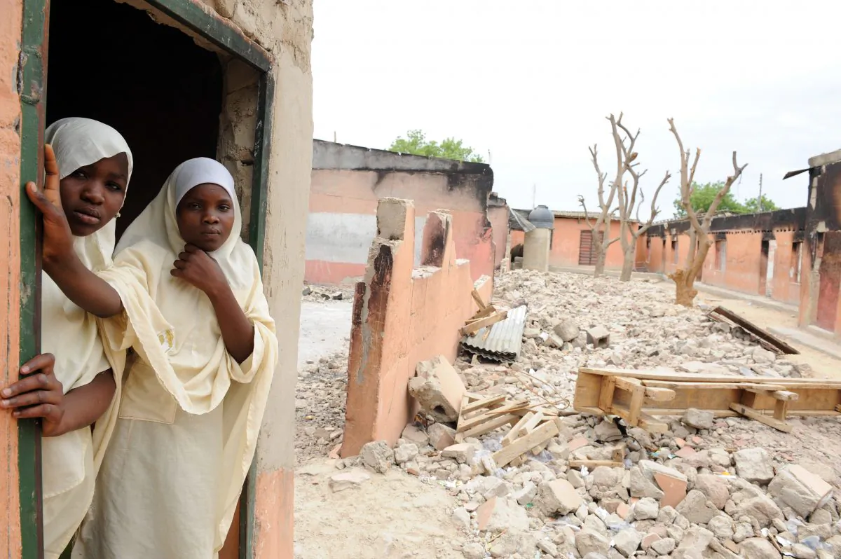 A female student stands in a burnt classroom at Maiduguri Experimental School, a private nursery, primary, and secondary school burnt by the Islamic terrorist group Boko Haram to keep children away from school in Maiduguri, northeastern Nigeria, on May 12, 2012. (Pius Utomi Ekpei/AFP/GettyImages)