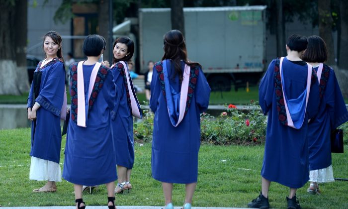 A group of students pose for photographs at a university in Beijing on June 8, 2015. (WANG ZHAO/AFP/Getty Images)