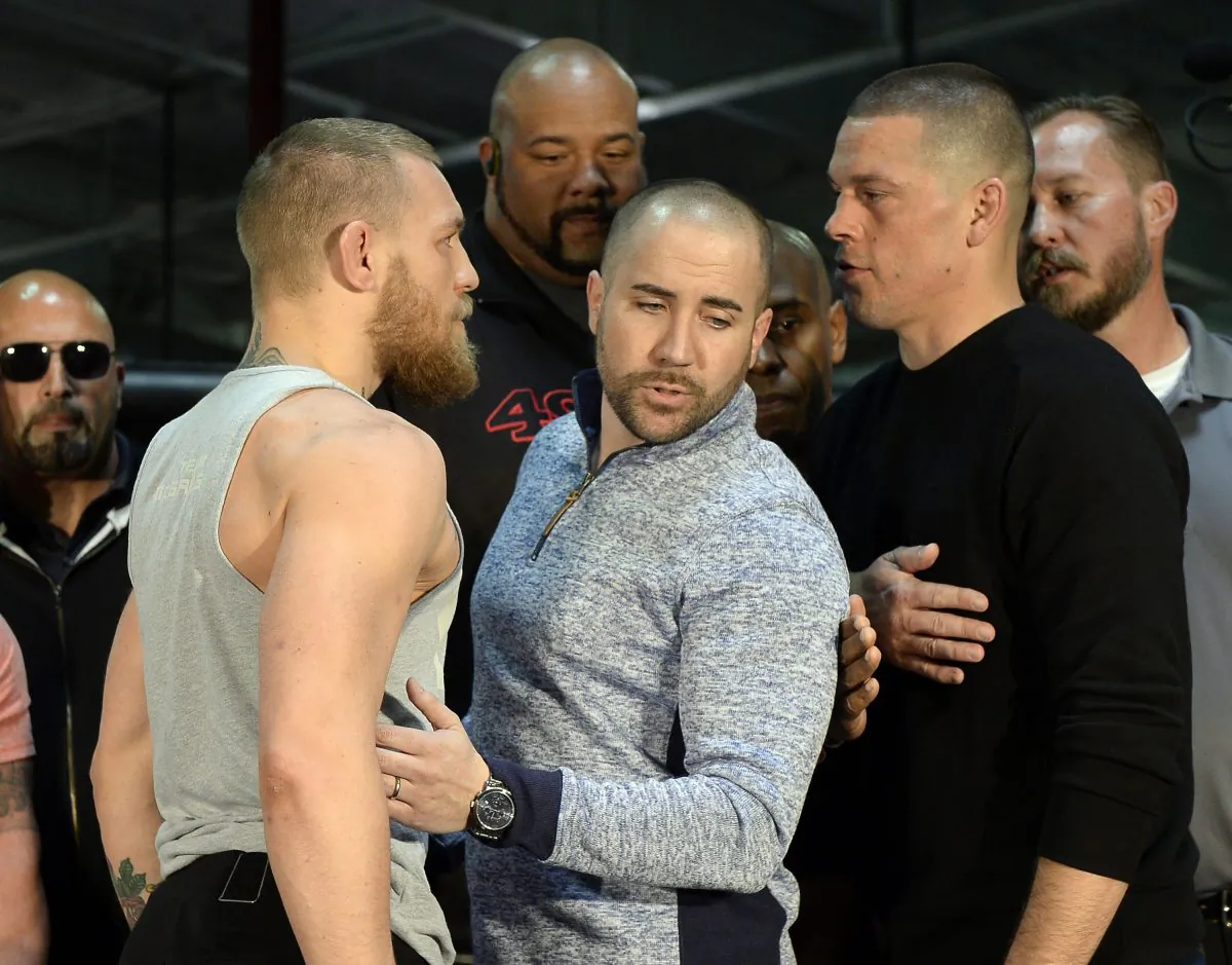 UFC featherweight champion Conor McGregor (L) and lightweight contender Nate Diaz (R) are held apart ahead of their welterweight match. (Kevork Djansezian/Getty Images)