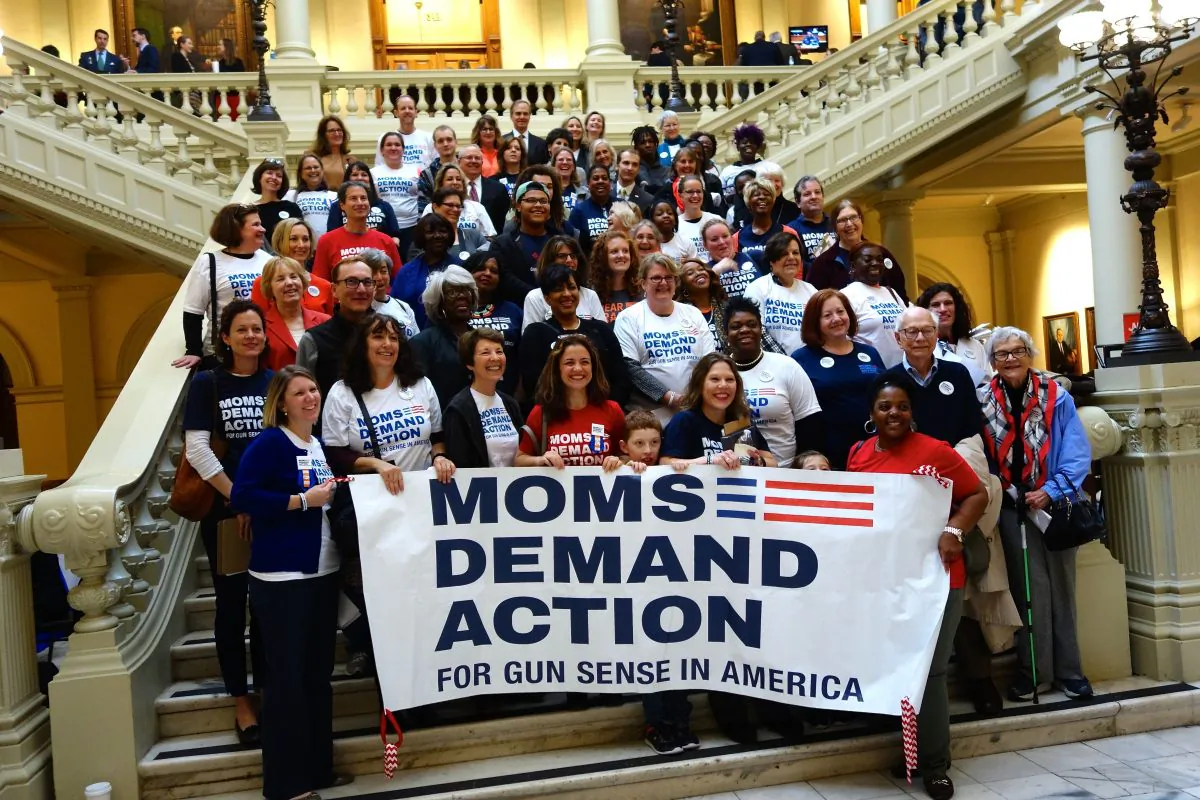 Moms Demand Action, who advocate for what they call "gun sense," pose on the steps of the Georgia Capitol in Atlanta on Feb. 24, 2016. Advocates, lobbyists, and students packed the building to talk to their representatives during the legislative session. (Mary Silver/Epoch Times)