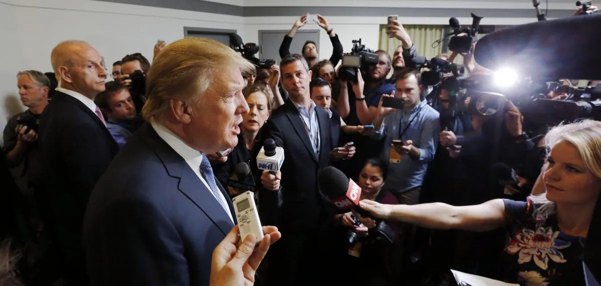 Republican presidential candidate Donald Trump talks to reporter before speaking at a No Labels Problem Solver convention Monday, Oct. 12, 2015, in Manchester, N.H. (AP Photo/Jim Cole)