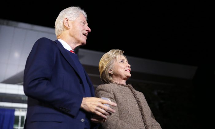Democratic presidential candidate Hillary Clinton and her husband, former President Bill Clinton, arrive onstage to speak at a "Get Out The Vote Rally" in Columbia, S.C., on Feb. 26, 2016. (AP Photo/Gerald Herbert)