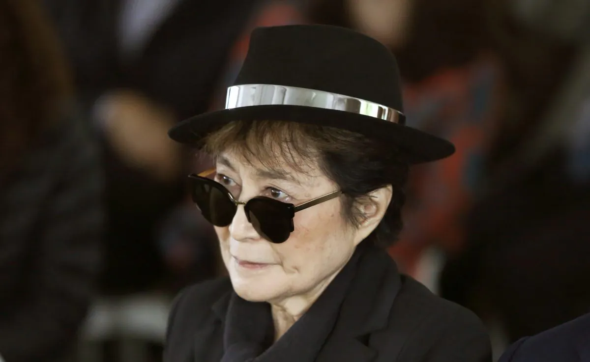 Artist Yoko Ono appears during a ceremony announcing the future installation of her first permanent public art installation in the U.S., in Chicago, June 12, 2015. Ono was hospitalized Feb. 26, 2016 for flu-like symptoms. (AP Photo/Charles Rex Arbogast)