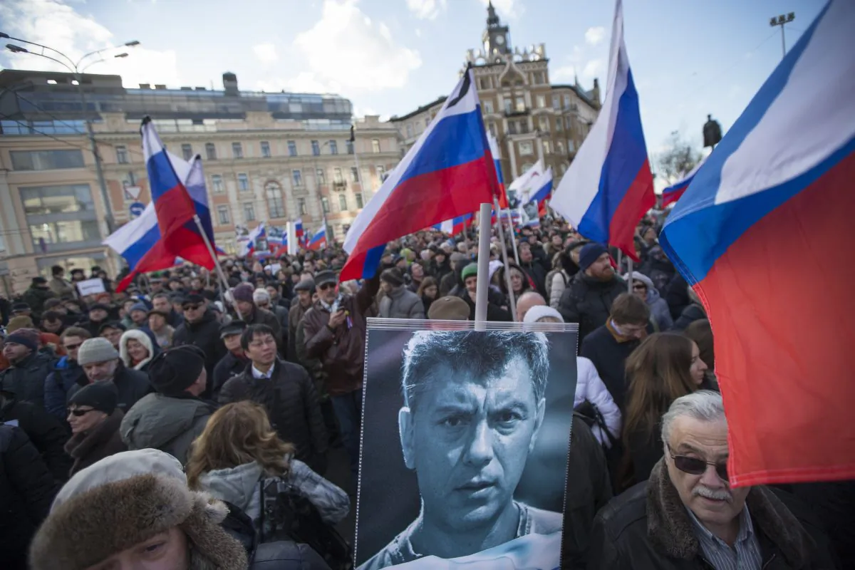 Demonstrators hold a portrait of slain opposition leader Boris Nemtsov and Russian flags during a march marking the one-year anniversary of his killing, in Moscow, Russia, on Feb. 27, 2016. Several thousand people took part in the march. (AP Photo/Ivan Sekretarev)