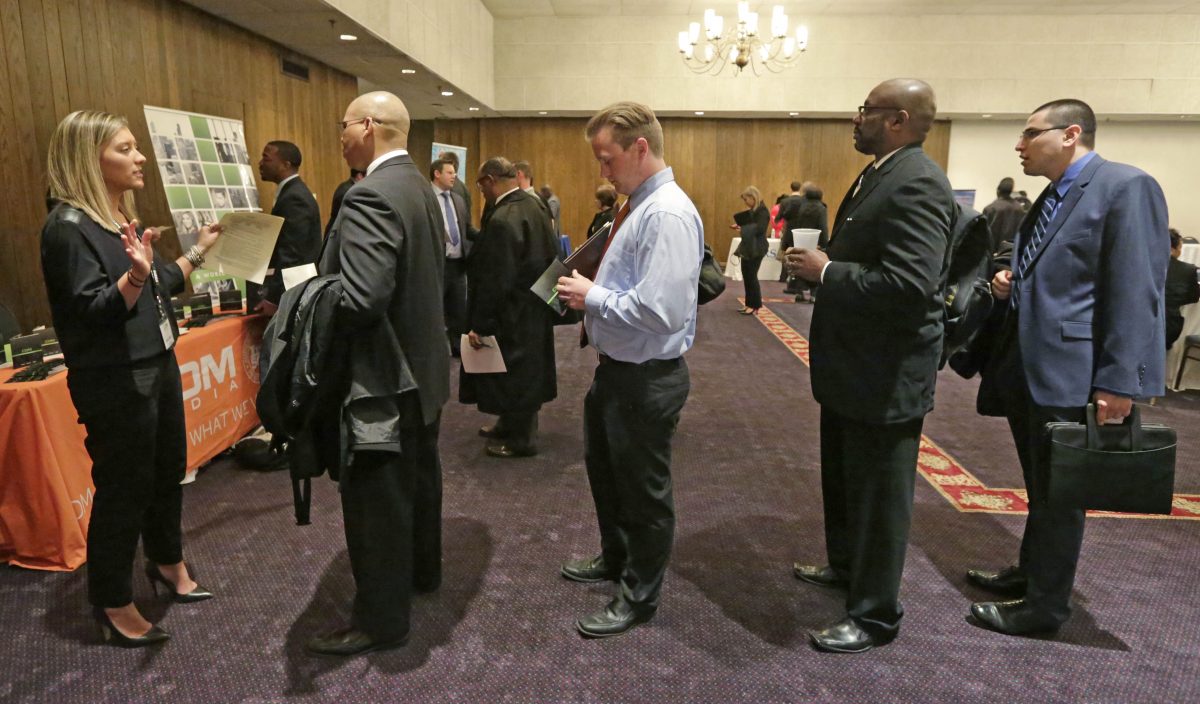 Bianca Medici (L), a corporate recruiter for CDM Media, speaks with job applicants during a National Career Fairs job fair in Chicago on April 22, 2015. The Labor Department releases weekly jobless claims on May 14, 2015. (AP Photo/M. Spencer Green)