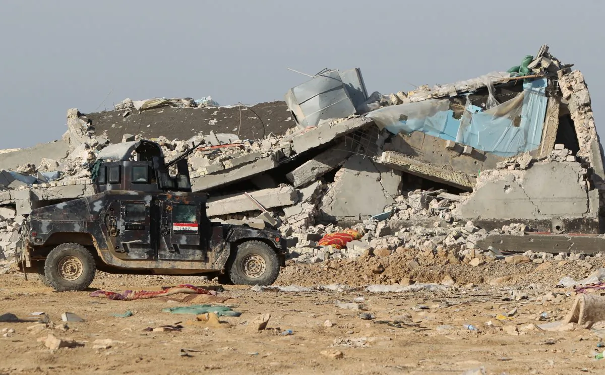 An armoured vehicle from the Iraqi forces drives past a destroyed building during military operations against Islamic State jihadists in the eastern suburbs of Ramadi, the capital of Iraq's Anbar Province, 120 kilometers west of Baghdad, on Feb. 1, 2016. (Ahmad al-Rubaye/AFP/Getty Images)