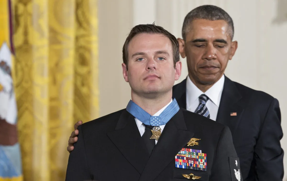President Barack Obama presents the Medal of Honor to Senior Chief Special Warfare Operator Edward Byers during a ceremony in the East Room of the White House in Washington, Monday, February 29, 2016. Navy Senior Chief Byers received the Medal of Honor for his courageous actions while serving as part of a team that rescued an American civilian being held hostage in Afghanistan on December 8-9, 2012. (AP Photo/J. Scott Applewhite)