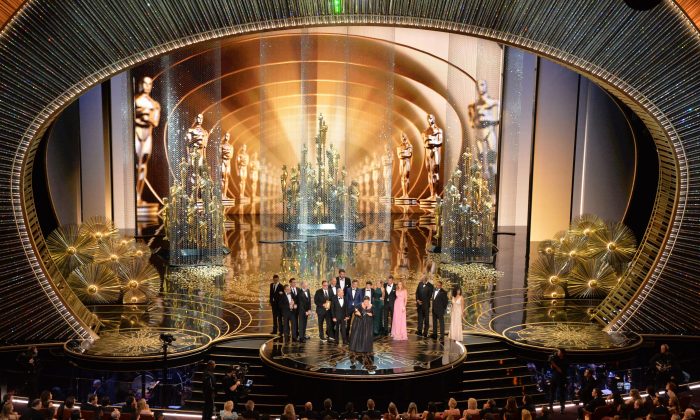 Members of the cast and producers of Spotlight accept the award for Best Picture at the 88th Oscars on February 28, 2016 in Hollywood, California. (MARK RALSTON/AFP/Getty Images)
