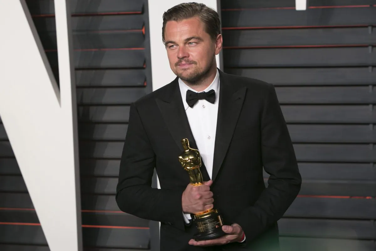 US actor Leonardo DiCaprio poses with his Best Actor award as he arrives to the 2016 Vanity Fair Oscar Party in Beverly Hills, California on Feb. 28, 2016. (Adrian Sanchez Gonzalez/Getty Images)