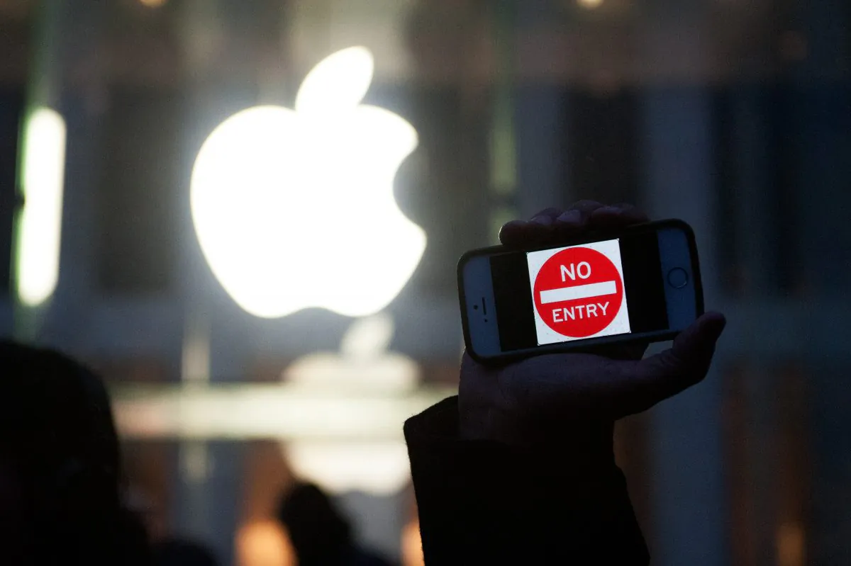 A protester holds up an iPhone that reads "No Entry" outside of the the Apple store on 5th Avenue in New York City on Feb. 23. While Apple claims to support user privacy in the United States, it has cooperated closely with authorities in China. (Bryan Thomas/Getty Images)