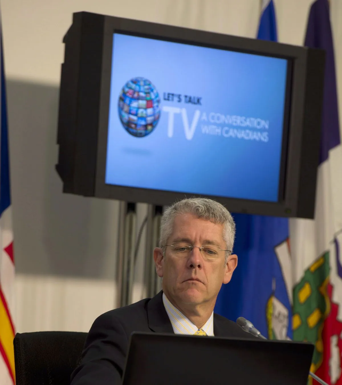 CRTC chairman Jean-Pierre Blais attends hearings on the future of television on Sept. 10, 2014, in Gatineau, Que. Cable and satellite TV companies are now required to offer their customers a basic service package for $25 or less. THE CANADIAN PRESS/Adrian Wyld