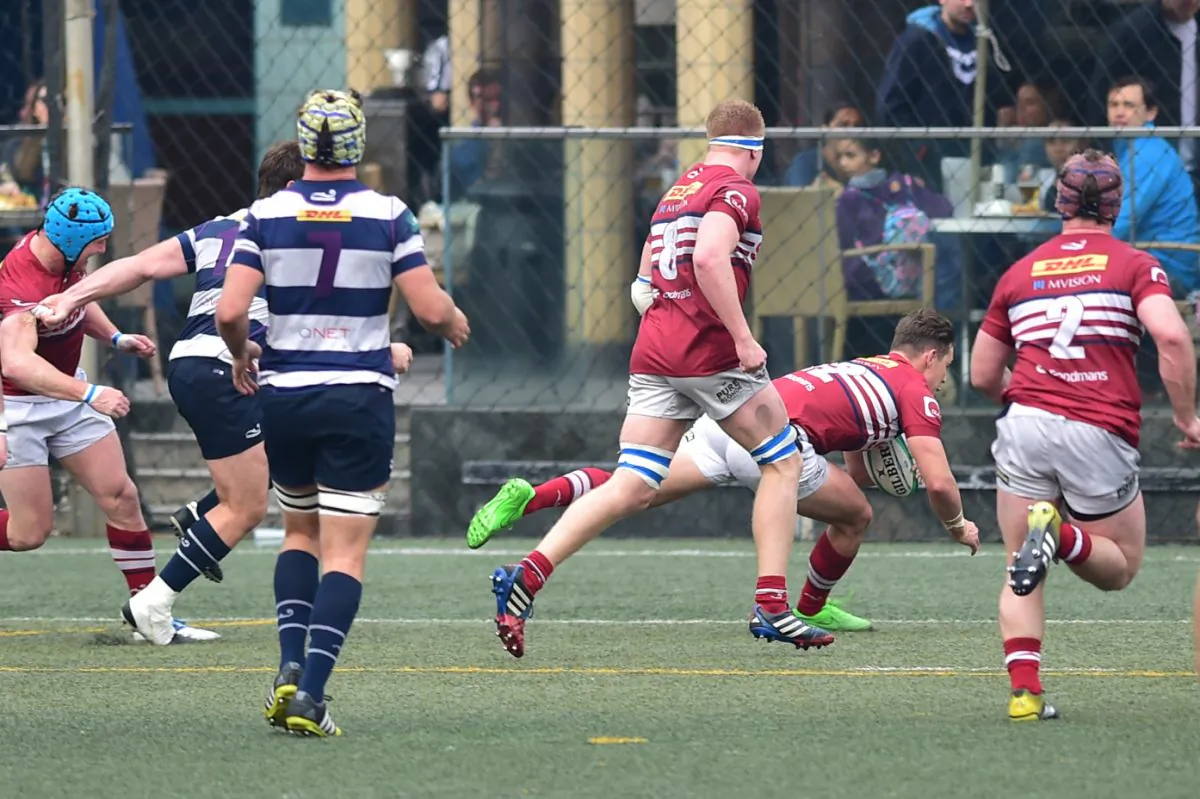 Richard Lankshear goes over for Sabre Kowloon’s second try of the match, also converted by Lankshear to give the visitor a 12-5 lead at half time in the HKRU Grand Championship Quarter Final against Natixis HKFC on Saturday Feb 27, 2016. In a nailbiting finish the Kowloon defence held out to win 18-12 to move them into the Semi-final against Leighton Asia HKCC this coming Saturday. (Bill Cox/Epoch Times)