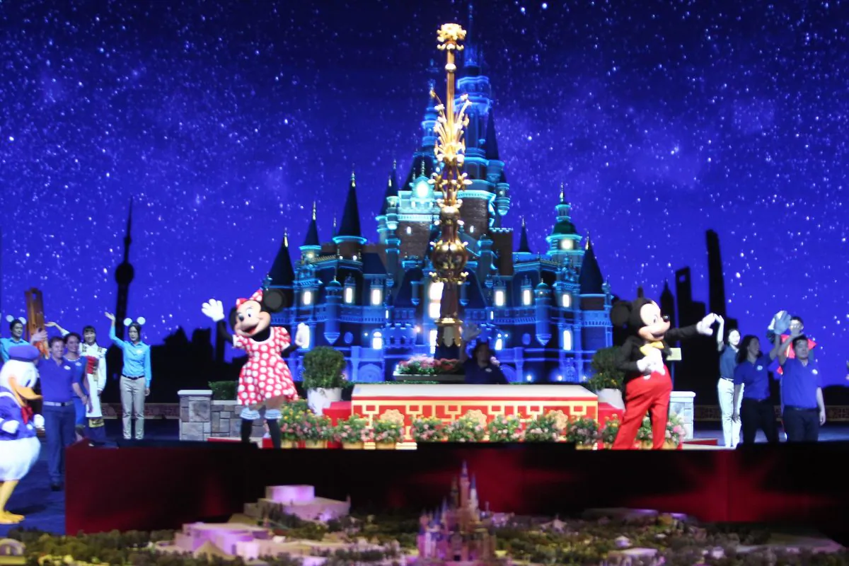 Two people dressed as Mickey and Minnie Mouse during the unveiling ceremony of six themed parks of Shanghai Disney Resort on July 15, 2015. One Chinese officials says children avoid Disney. (China Photo Press/Getty Images)