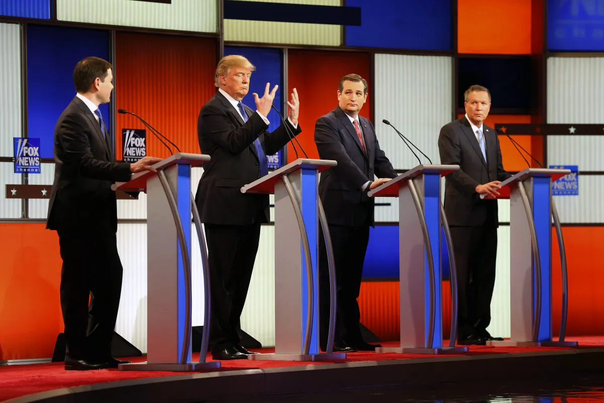 Republican presidential candidate, Donald Trump, second from left, gestures as Sen. Marco Rubio, R-Fla., Sen. Ted Cruz, R-Texas, and Ohio Gov. John Kasich watch him a Republican presidential primary debate at Fox Theatre on March 3, 2016, in Detroit. (AP Photo/Paul Sancya)
