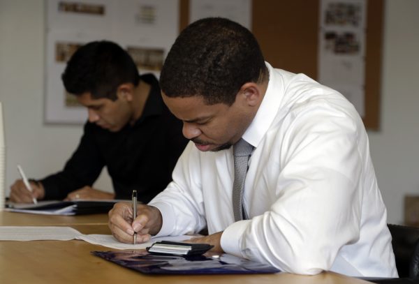 Reece Lightner fills out a job application for a server at a job fair held by The Genuine Hospitality Group, in Miami, on Jan. 27, 2016, as the restaurant group is expanding in South Florida and hiring for all positions at its restaurants. (AP Photo/Lynne Sladky)