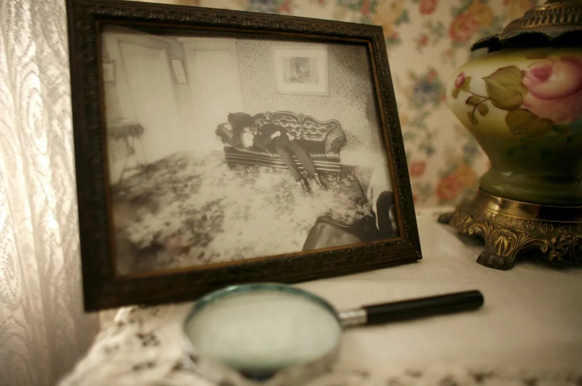 A crime scene photograph of Lizzie Borden's father Andrew Borden appears in the room of the former family home where he was killed in the infamous 1892 double murder, in Fall River, Mass., Wednesday, Aug. 20, 2008. (AP Photo/Steven Senne)