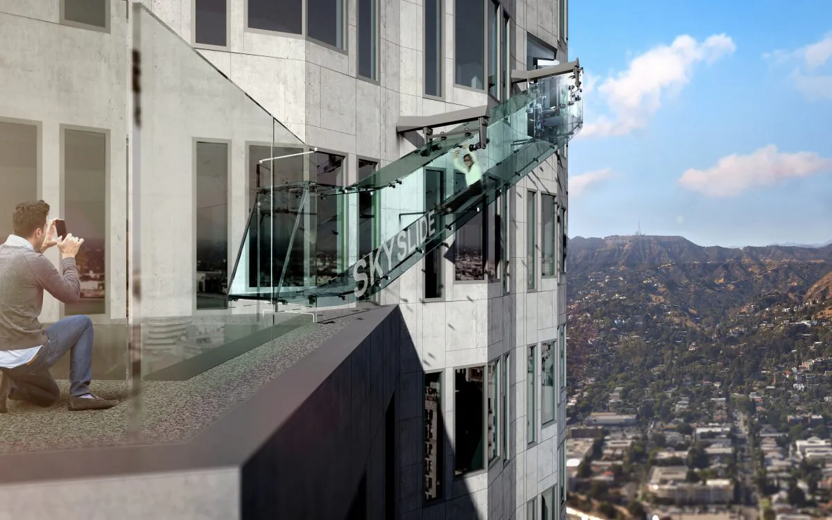 This undated artist's rendering provided by Overseas Union Enterprise Limited shows a glass slide 1,000 feet above the ground off the side of the U.S. Bank Tower in downtown Los Angeles. The 45-foot-long attraction is part of a $50 million renovation that will also put a bar and open-air observation deck on the top floors of the 72-story building. (Michael Ludvik/ OUE Ltd. via AP)