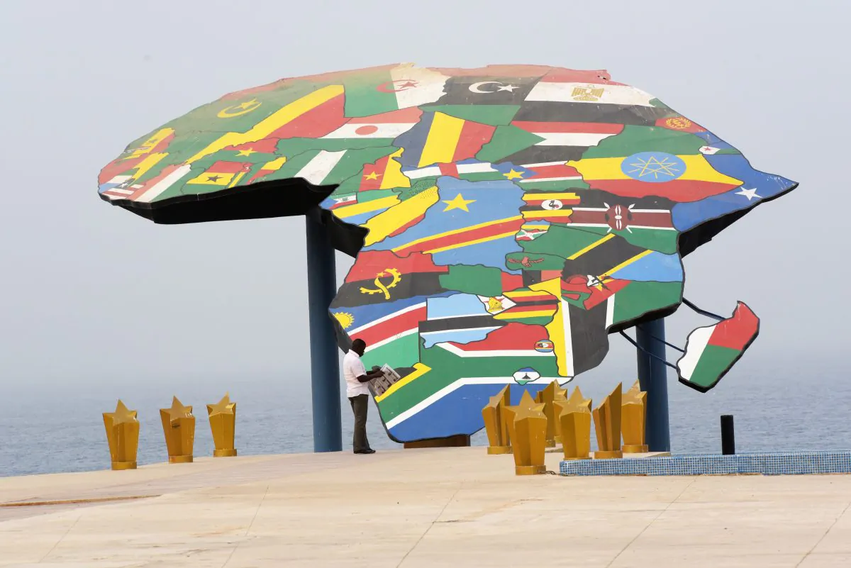 A man reads his newspaper in front a map of Africa at the Place du Souvenir Africain, in Dakar, on Jan. 27, 2016. (Seyllou/AFP/Getty Images)
