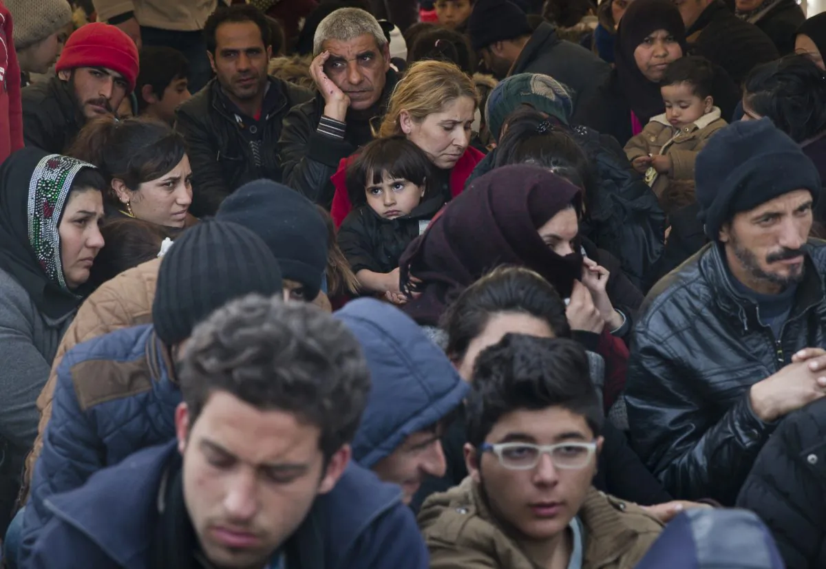 Migrants wait near the border gate at the northern Greek border station of Idomeni on March 6, 2016. Greek police officials saidy Macedonian authorities have imposed further restrictions on refugees trying to cross the border, saying only those from cities they consider to be at war can enter. (AP Photo/Vadim Ghirda)