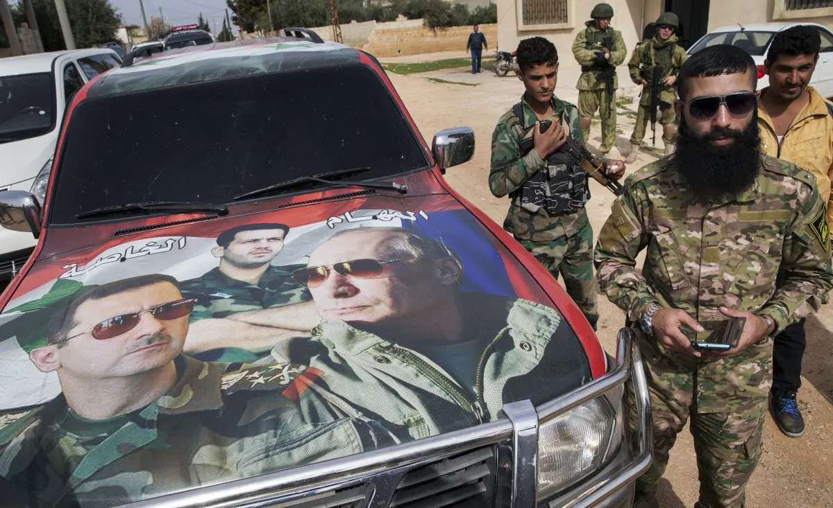 In this March 2, 2016, file photo, Syrian solders and Russian solders, who escort a group of journalists in the background, stand near a car covered by collage showing photos of faces of Russian President Vladimir Putin, right, Syrian President Bashar Assad, left, and a Syrian general, President's Assad brother, Maher Assad, center, in Maarzaf, about 15 kilometers west of Hama. (AP Photo/Pavel Golovkin, File)