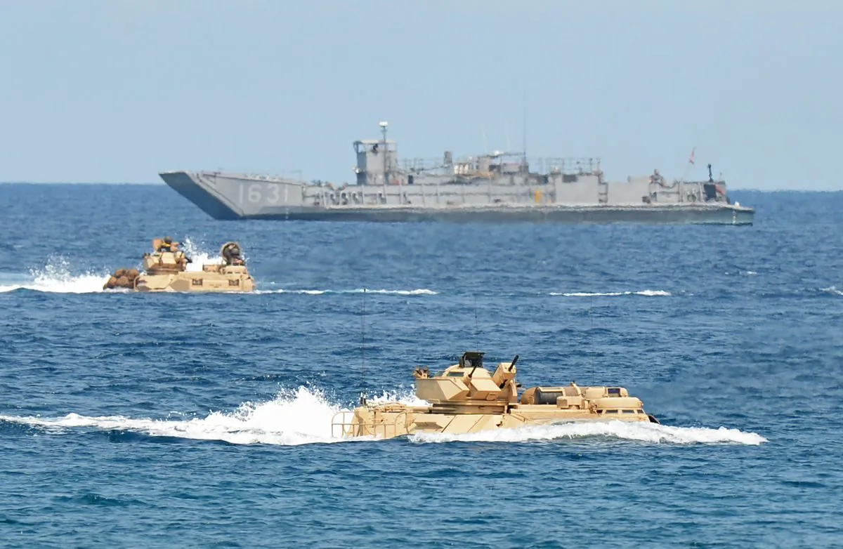 Amphibious assault vehicles of the U.S. Marines speed past a landing ship during an amphibious landing exercise on a beach at San Antonio in Zambales province on April 21, 2015. The exercise was part of the annual Philippine-US joint maneuvers some 137 miles east of the Scarborough Shoal in the South China Sea. (Ted Aljibe/AFP/Getty Images)