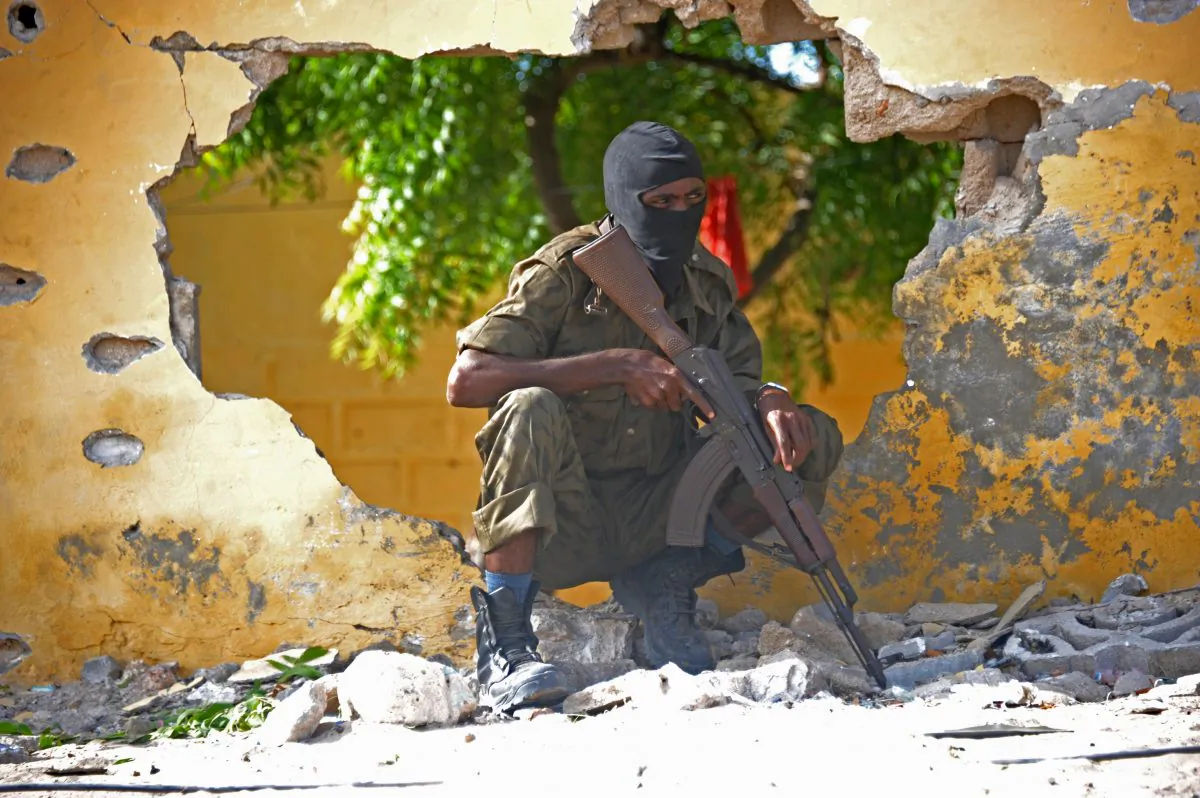 A Somali soldier stands guard next to the site where Al Shebab militants carried out a suicide attack against a military intelligence base in Mogadishu on June 21, 2015. (Mohamed Abdiwahab/AFP/Getty Images)