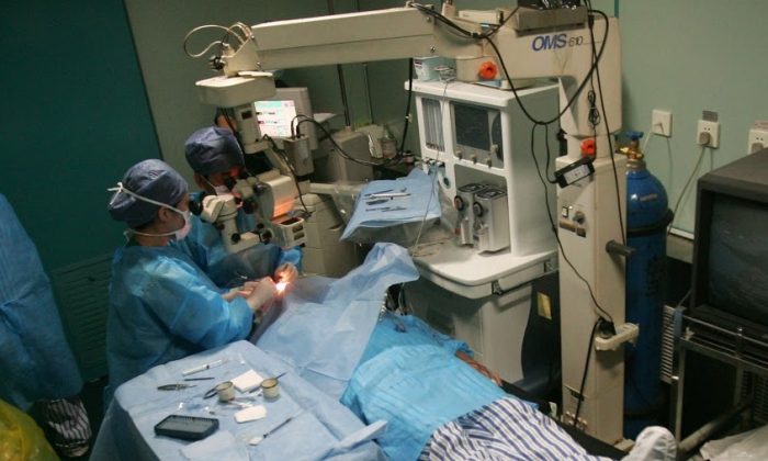 Doctors carry out a free cataract removal surgery for a patient on the Lifeline Express May 11, 2008 in Nanyang of Henan Province, China. (China Photos/Getty Images)