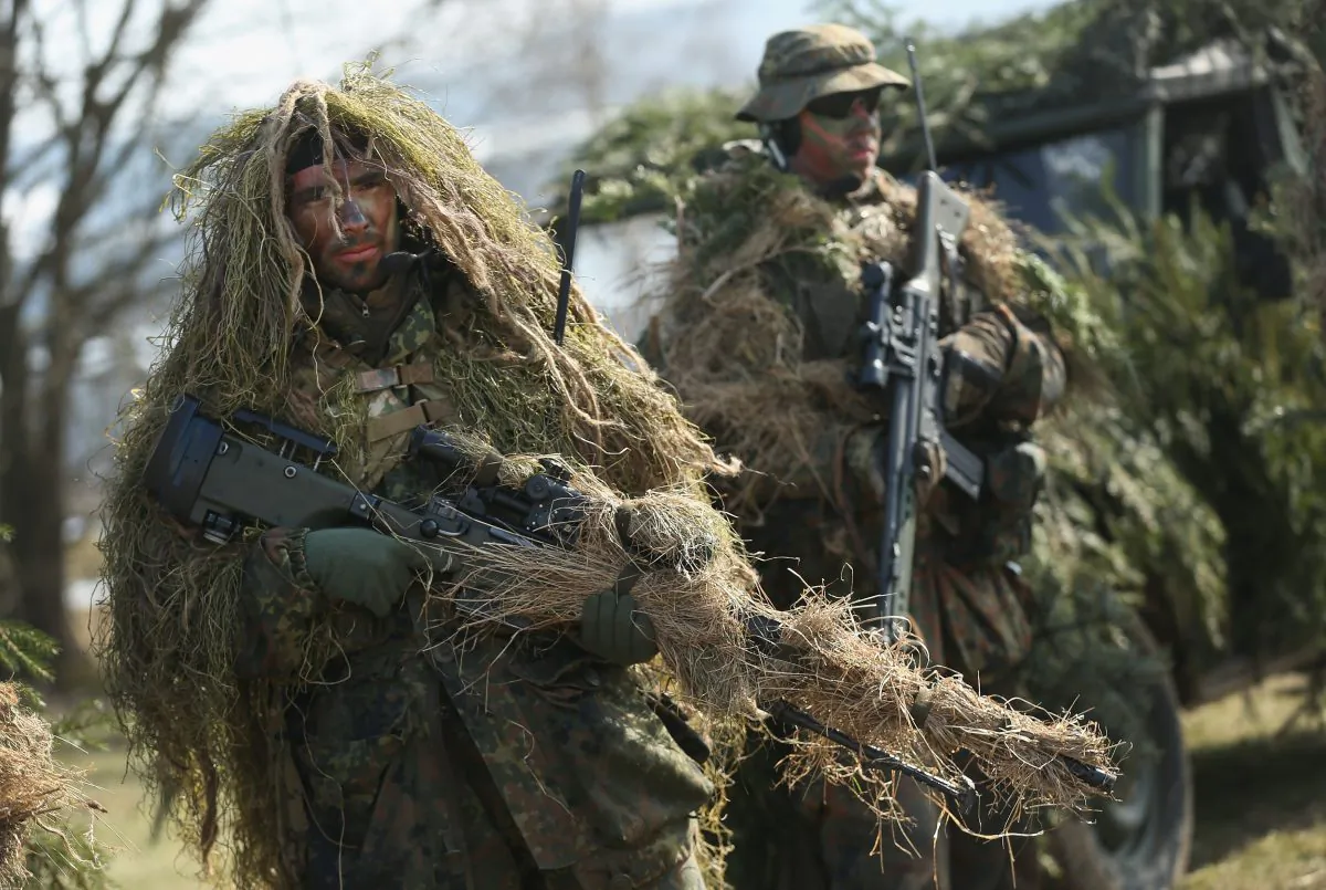 Members of the German Bundeswehr's 371st Armoured Infantry Battalion stand in camouflage with sniper rifles during a media event at the battalion's base in Marienberg, Germany on March 10, 2015. (Sean Gallup/Getty Images)
