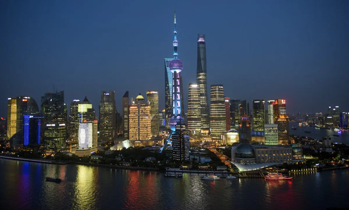 Ships pass by the skyline of the Pudong Financial District in Shanghai on Aug. 14, 2015.  (Johannes Eisele/AFP/Getty Images)