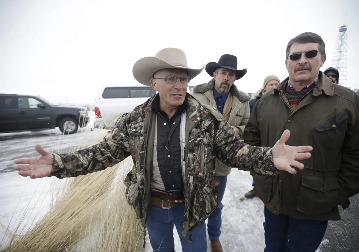 In this Jan. 9, 2016 file photo, Robert LaVoy Finicum, left, a rancher from Arizona, talks to reporters at the Malheur National Wildlife Refuge near Burns, Ore. On Tuesday, March 8, 2016, authorities said police were justified in killing Finicum during a traffic stop on Jan. 26, 2016. (AP Photo/Rick Bowmer, file)