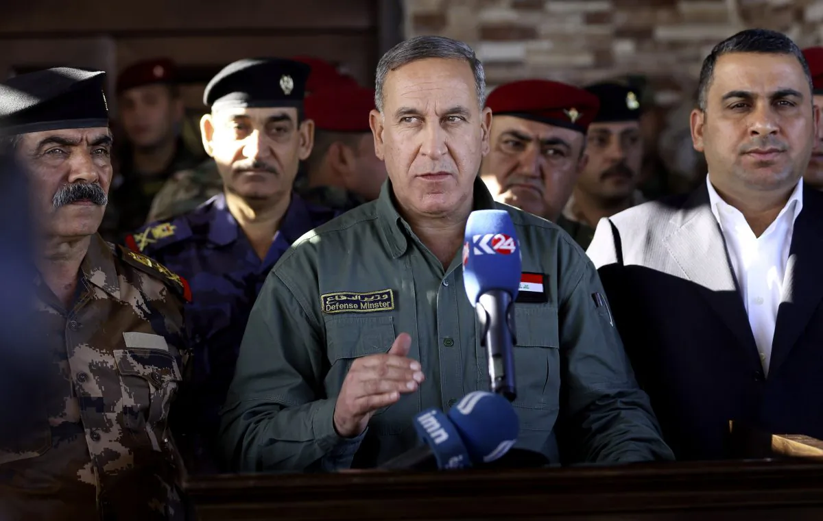 Iraqi Defense Minister Khaled al-Obeidi (C) speaks to reporters at a military a base outside Tikrit, 80 miles north of Baghdad, Iraq, on March 9, 2016. Al-Obeidi played down fears of the Islamic State’s chemical weapons capabilities, saying the group lacks “chemical capabilities.” The attacks the group has carried were only intended to “hurt the morale of our fighters,” as they have so far not caused any casualties he said. (AP Photo/Hadi Mizban)