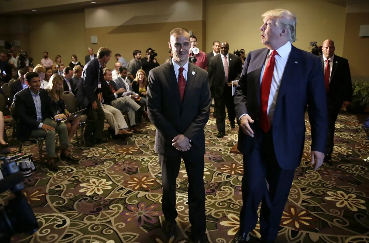 Republican presidential candidate Donald Trump walks with his campaign manager Corey Lewandowski, left, after speaking at a news conference, Tuesday, Aug. 25, 2015, in Dubuque, Iowa. (AP Photo/Charlie Neibergall)