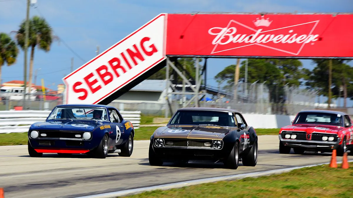 William Foster in the #6 1971 Sunoco Penske Camaro, Brian Ferrin in the #13 Camaro Trans-Am, and Ross Myers in the #98 Mercury Cougar pass under the Budweiser bridge at Sebring Raceway during the SVRA Spring Vintage Classic. (Bill Kent/Epoch Times)