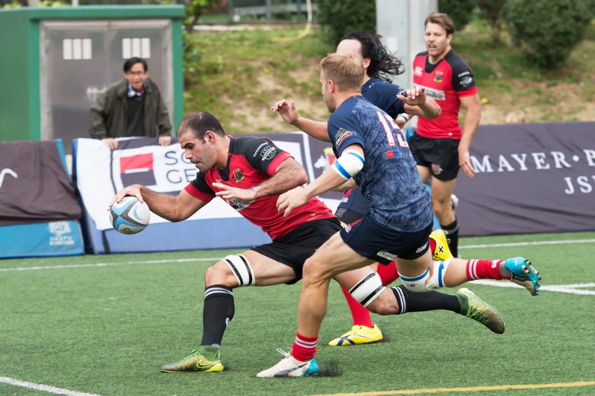 After forcing his way through tackles by Alessandro Nardoni and Jack Parfit of Hong Kong Scottish in a 20 metre run, an inspired Thomas Lomboley runs for the line to score his first of 2 tries for Valley in their Grand Championship Semifinal at Valley on Saturday March 5. (Bill Cox/Epoch Times)
