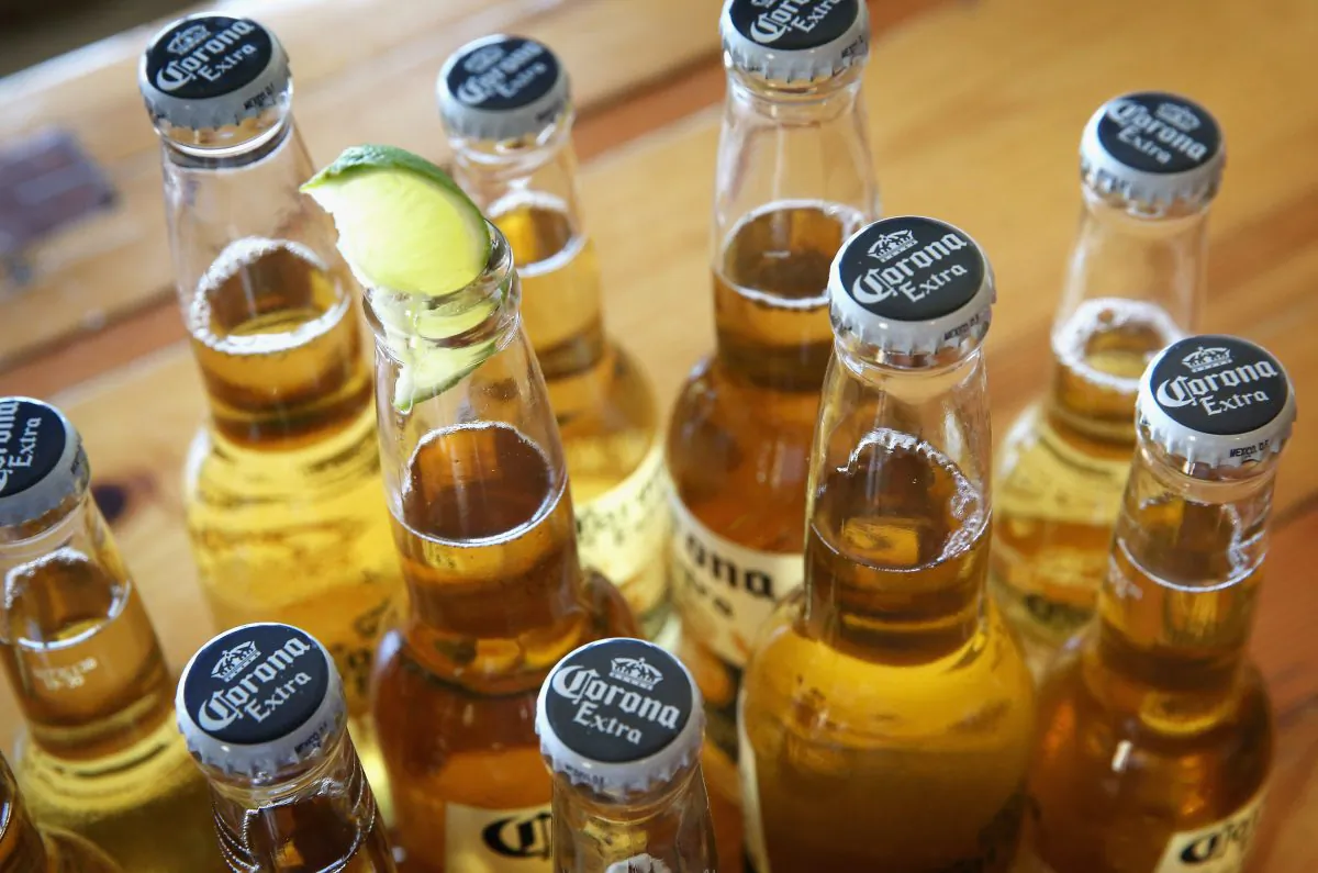 CHICAGO, IL - JUNE 07: In this photo illustration, bottles of Corona beer are shown on June 7, 2013 in Chicago, Illinois. Constellation Brands, one of the world's largest wine companies, is expected to become the third-largest beer supplier in the United State today with a $5.3 billion purchase of the U.S. distribution rights of Grupo Modelo beers from Anheuser Busch InBev. Corona Extra, brewed by Grupo Modelo, is the number one selling imported beer sold in the United States and the number six selling beer overall. (Photo Illustration by Scott Olson/Getty Images)