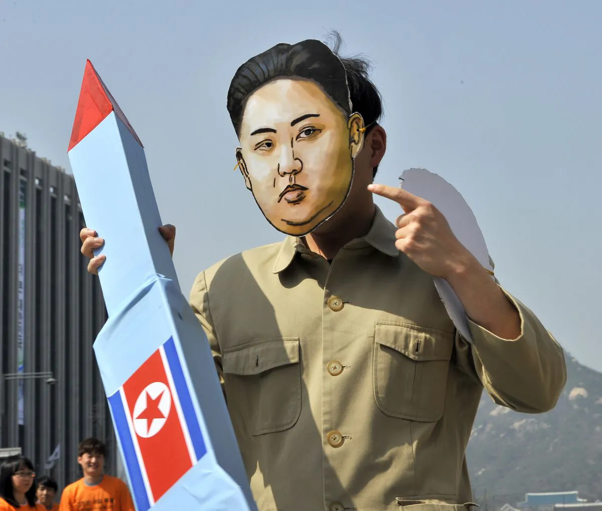 A South Korean activist wearing a mask of North Korean leader Kim Jong-Un holds a mock missile during a rally denouncing North Korea's rocket launch and the three-generational dictatorship, in Seoul on April 15, 2012. (JUNG YEON-JE/AFP/Getty Images)