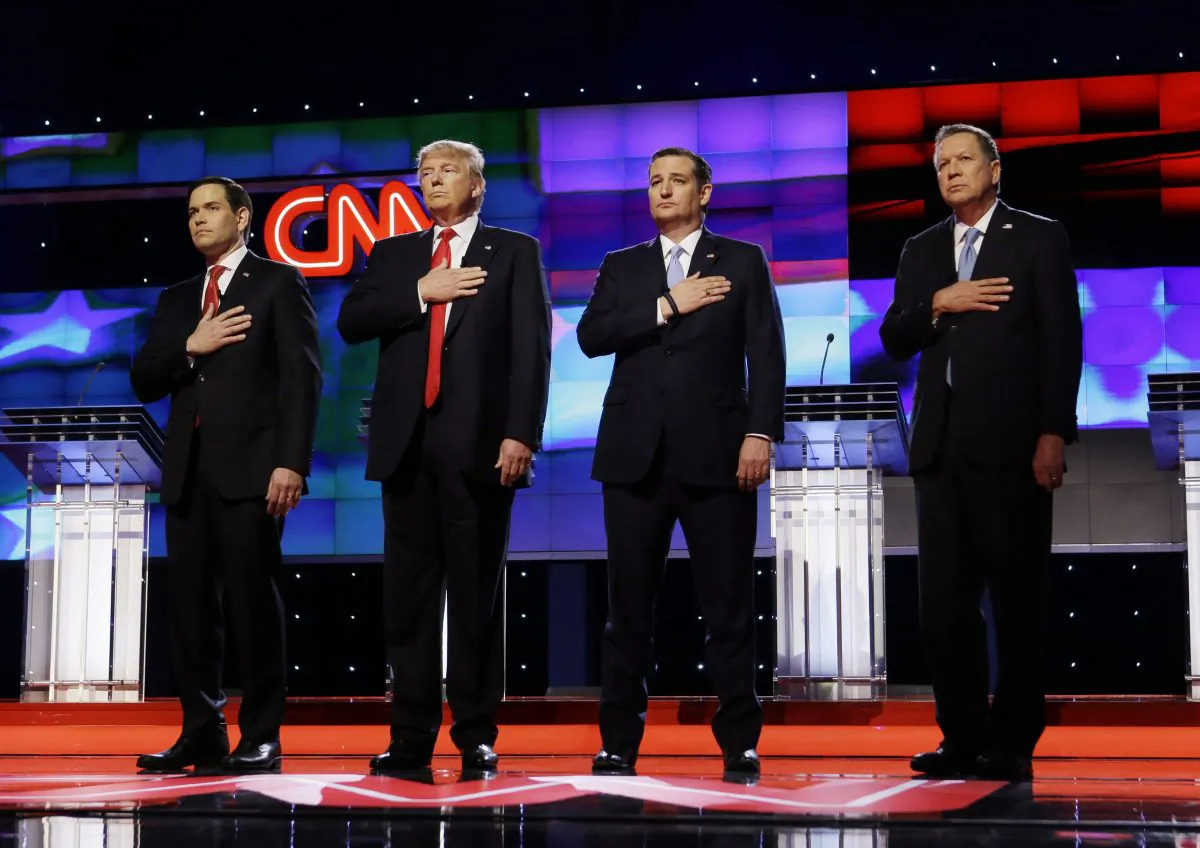 Republican presidential candidates, Sen. Marco Rubio, R-Fla., from (L), Donald Trump, Sen. Ted Cruz, R-Texas, and Ohio Gov. John Kasich, stand together during the signing of the National Anthem, before the start of the Republican presidential debate sponsored by CNN, Salem Media Group and the Washington Times at the University of Miami,  on March 10, 2016, in Coral Gables, Fla. (AP Photo/Wilfredo Lee)