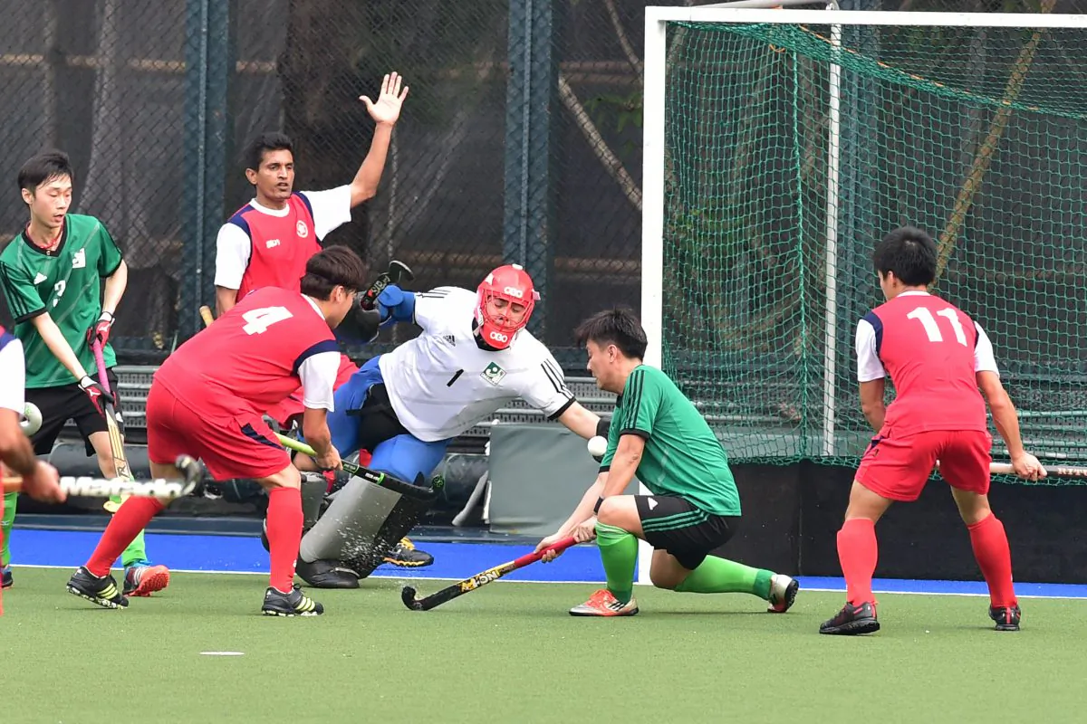 Goalmouth action between Hong Kong (in red) and Macau in the senior Interport hockey fixture at King’s Park on Sunday March 6, 2016. (Bill Cox/Epoch Times)