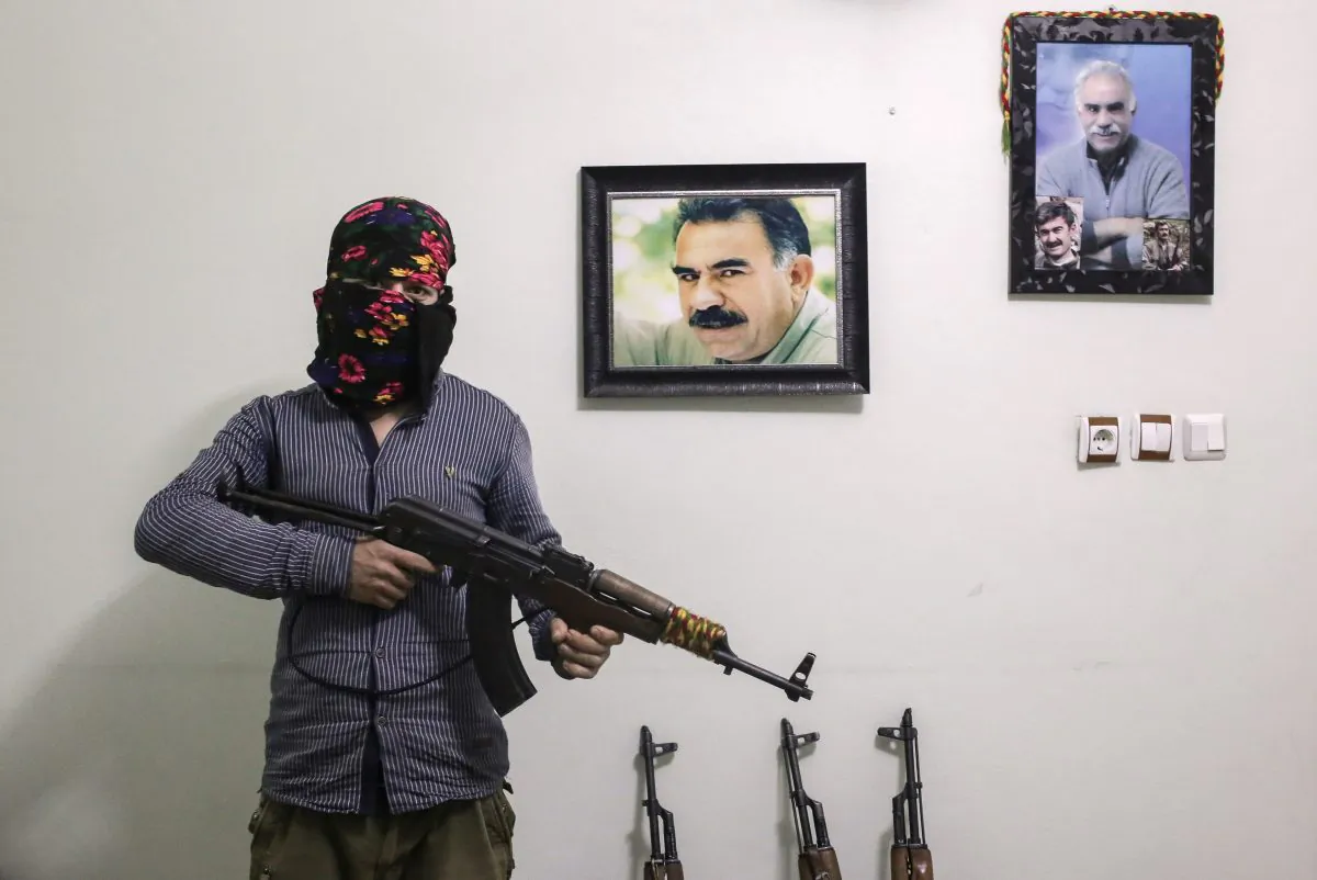 A member of a armed group Patriotic Revolutionary Youth Movement (YDG-H), a youth division of the Kurdistan Workers' Party (PKK), with his AK-47 next to pictures of the jailed Kurdish rebel leader Abdullah Ocalan in a house in southeastern Turkish city of Nusaybin, Turkey, on Feb. 25, 2016. Since mid-December, the Turkish security forces placed to several predominantly Kurdish cities in Turkey under 24-hour martial law and curfew on the premise of restoring public order. (Cagdas Erdogan/Getty Images)